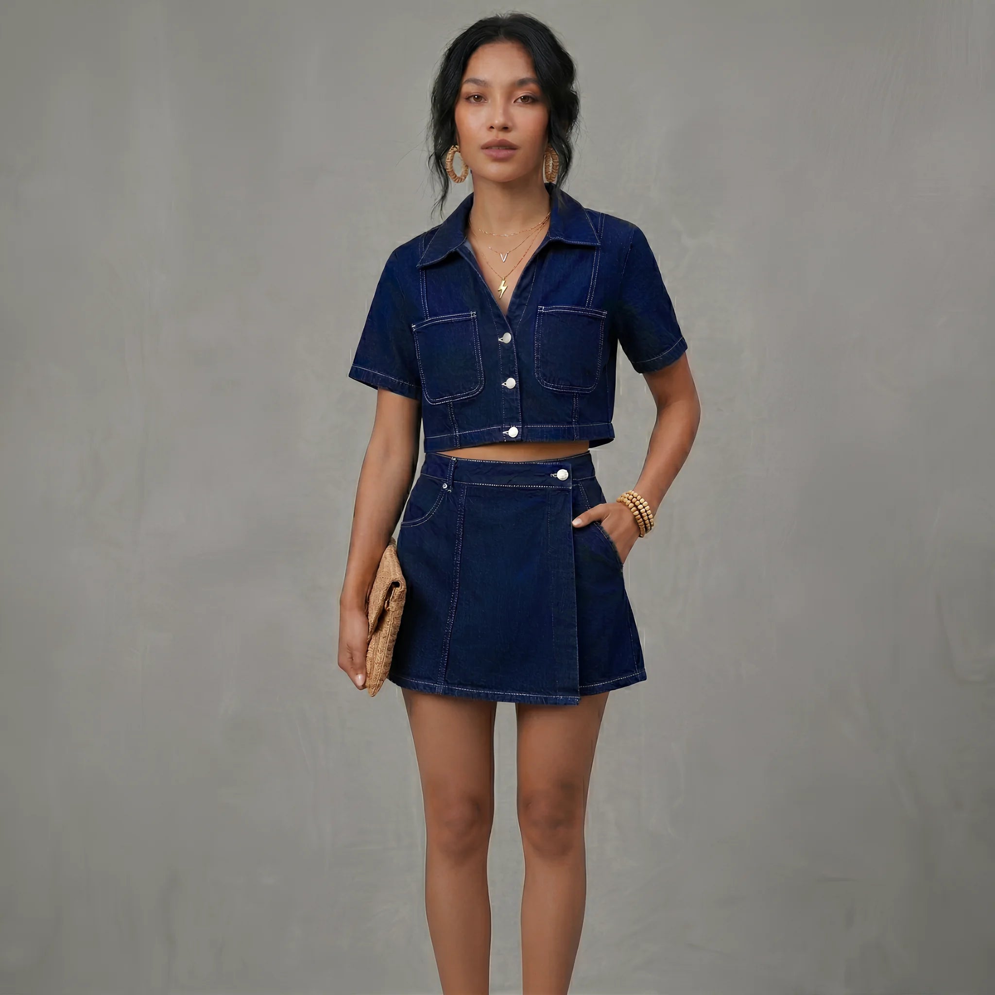 Woman wearing a blue denim outfit against a gray background