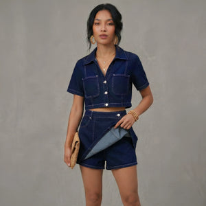 Woman wearing a denim outfit against a gray background