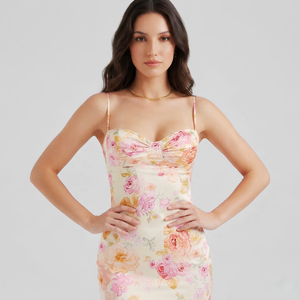 Woman wearing a floral dress on a plain background