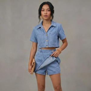 Woman wearing a denim outfit against a gray background
