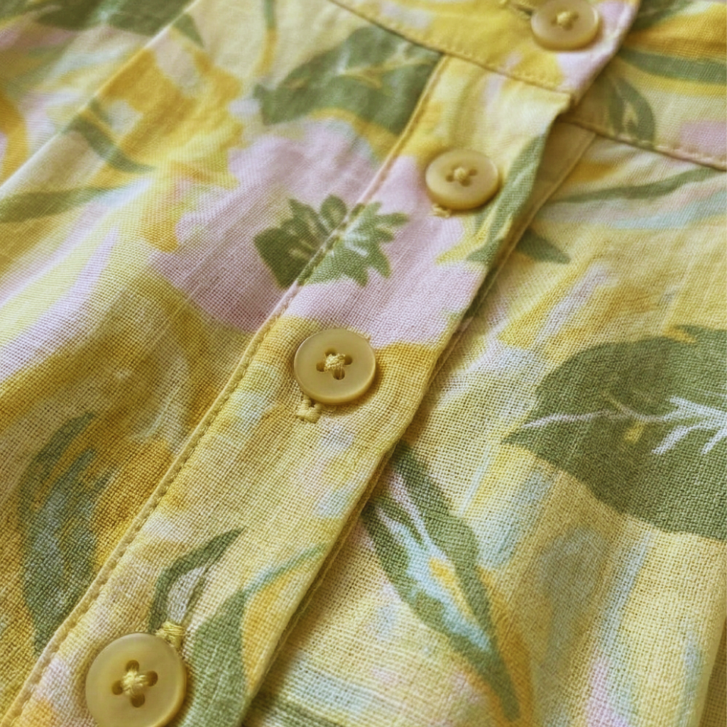 Close-up of a yellow floral shirt with buttons