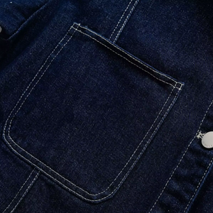 Close-up of a dark blue denim pocket with stitching details.