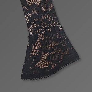 Black lace fabric on a gray background