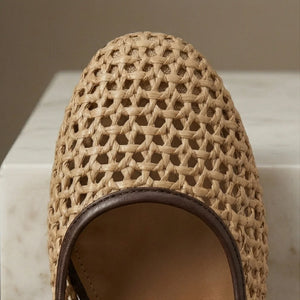 Close-up of a woven sandal on a marble surface