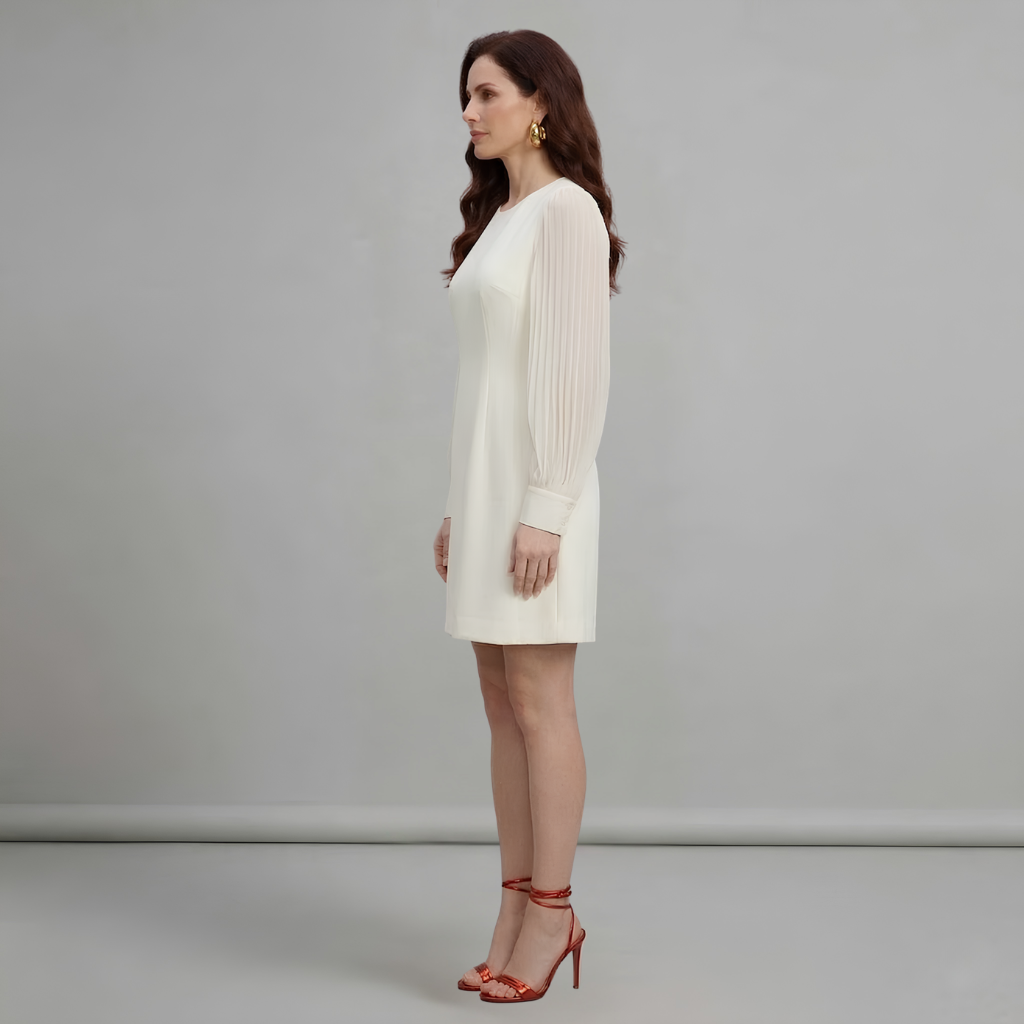 Woman wearing a white dress against a gray background