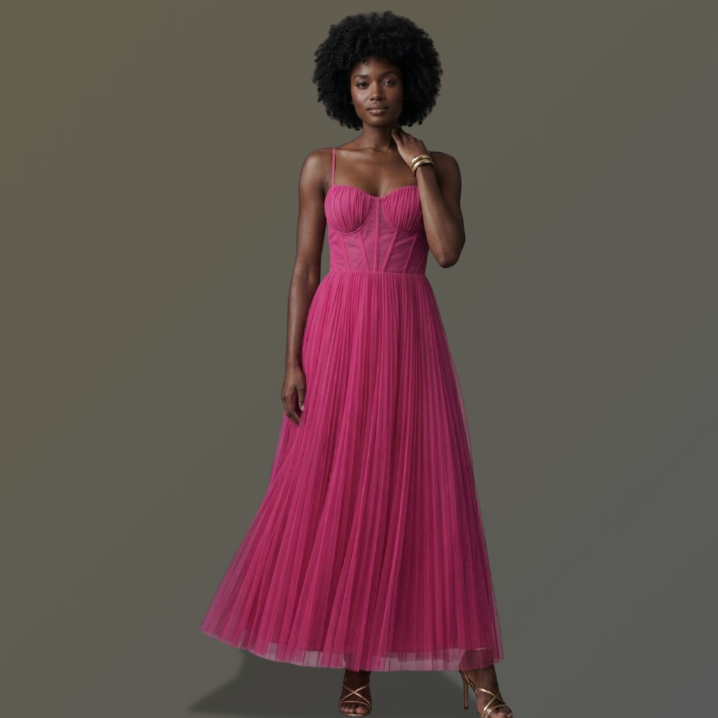 Woman wearing a pink dress against a gray background