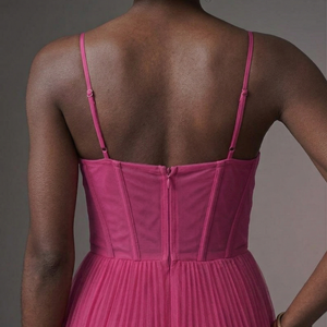 Pink dress with thin straps on a neutral background