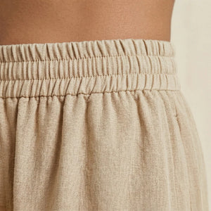 Close-up of beige pants with an elastic waistband