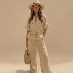 Woman in beige outfit with hat and bag against a beige background