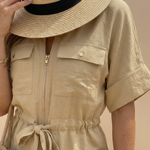Beige outfit with a straw hat on a neutral background