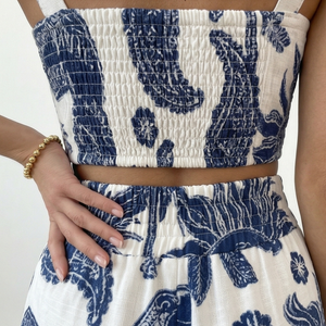 Blue and white floral patterned outfit on a plain background