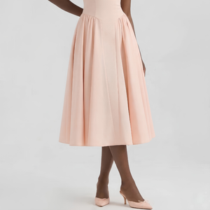 Person wearing a light pink dress with brown shoes on a white background