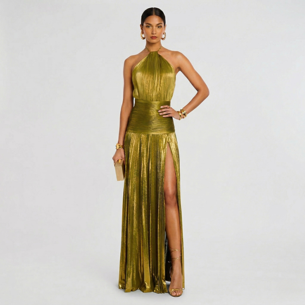 Woman wearing a gold evening gown with a high slit on a light gray background
