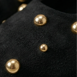 Close-up of black fabric with gold studs