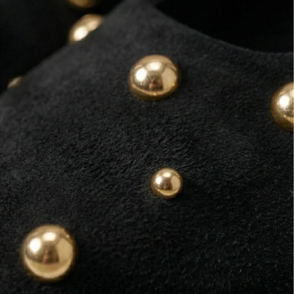 Close-up of black fabric with gold studs