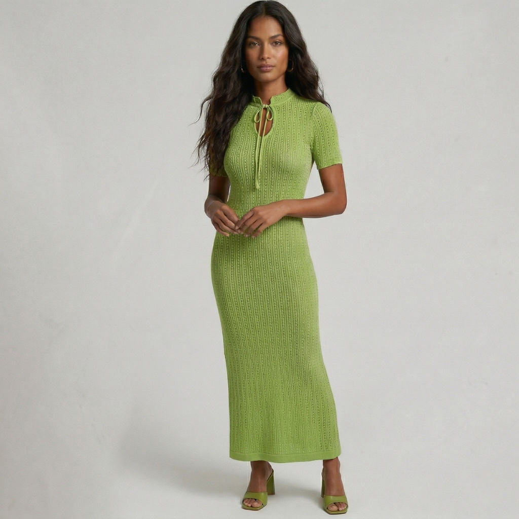 Woman wearing a green dress against a plain background