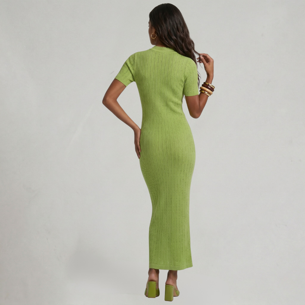 Woman wearing a green dress against a gray background