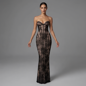 Woman wearing a black lace strapless gown on a gray background