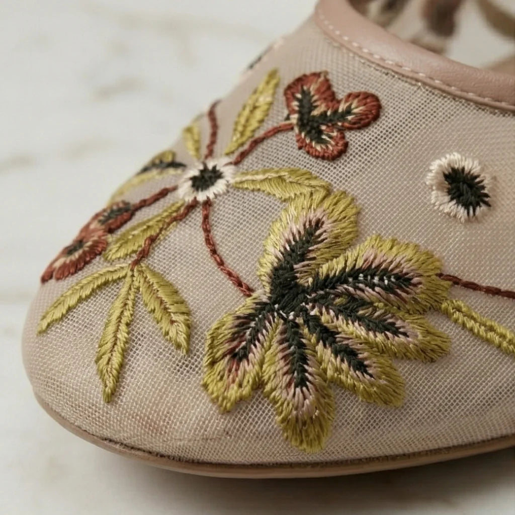 Embroidered shoe with floral design on a beige background