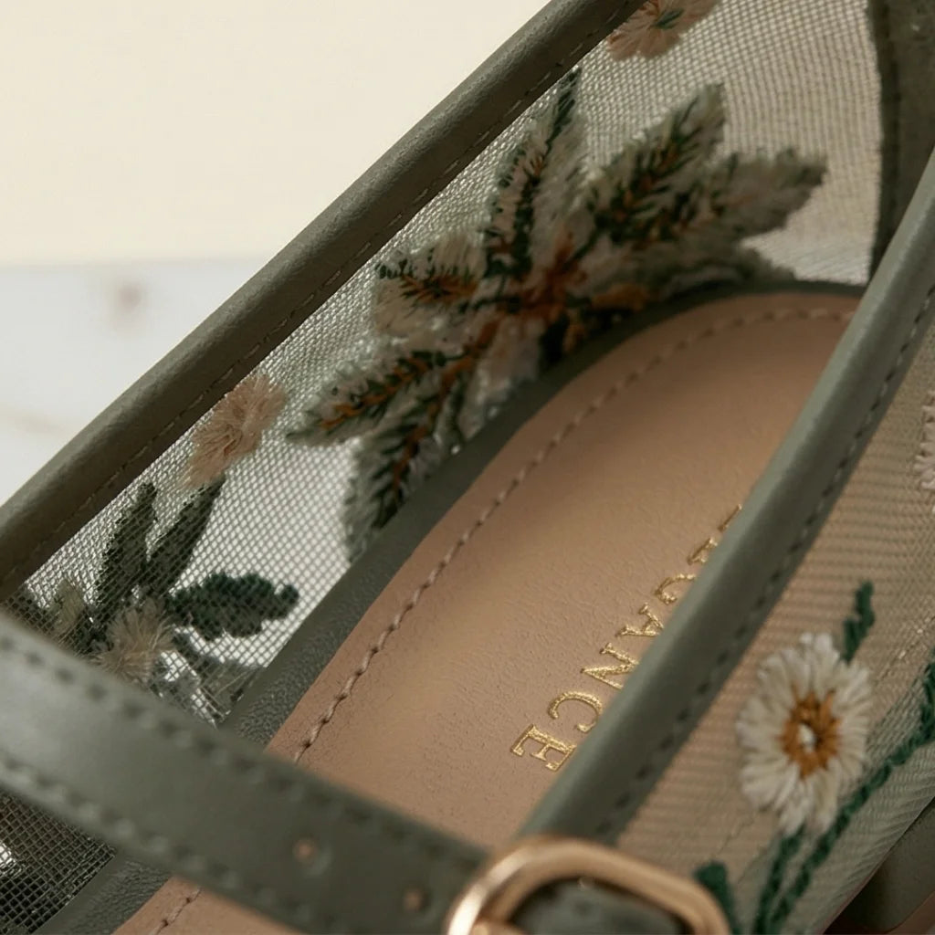 Close-up of a sandal with floral embroidery and 'Vancress' branding.