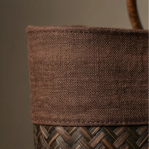 Close-up of a brown woven basket with a textured fabric top.