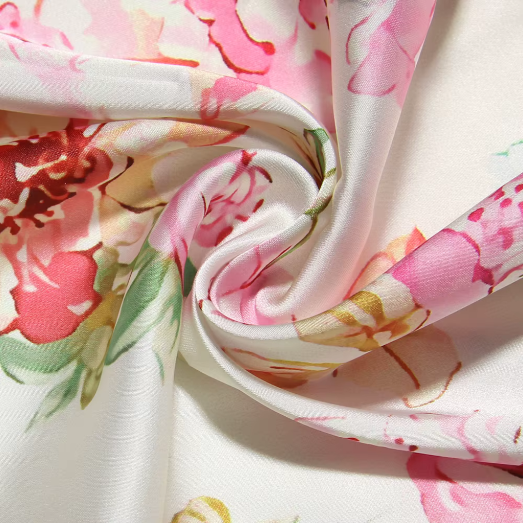 Floral fabric with pink and red flowers on a white background