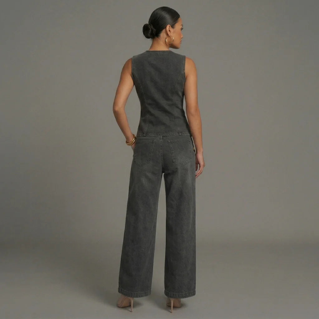 Woman wearing a gray sleeveless top and wide-leg pants against a plain background