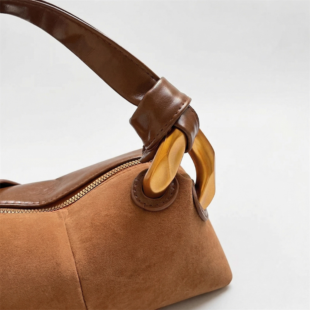 Brown handbag with wooden handle on a white background