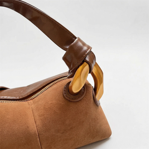Brown handbag with wooden handle on a white background
