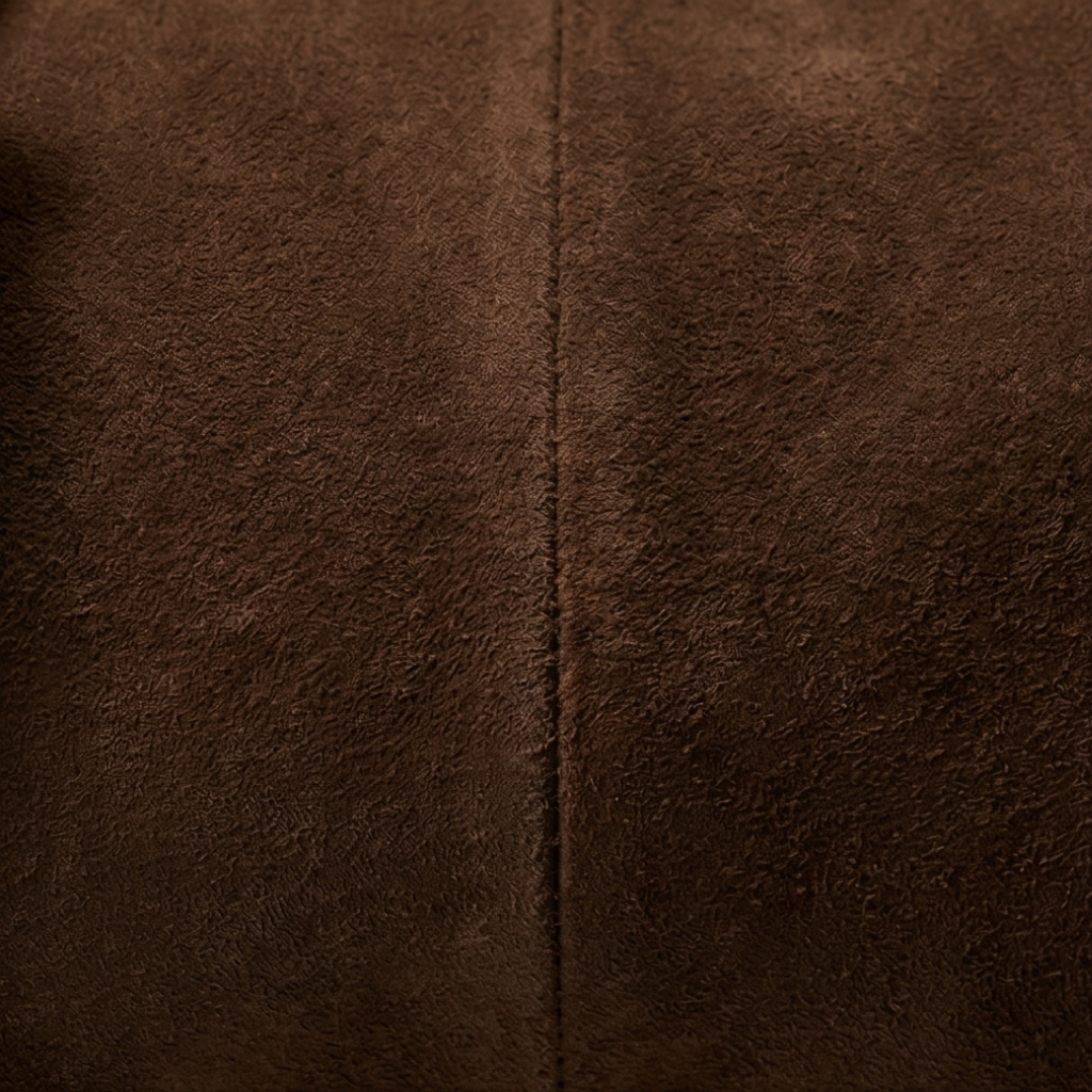 Close-up of brown textured fabric with a visible seam.