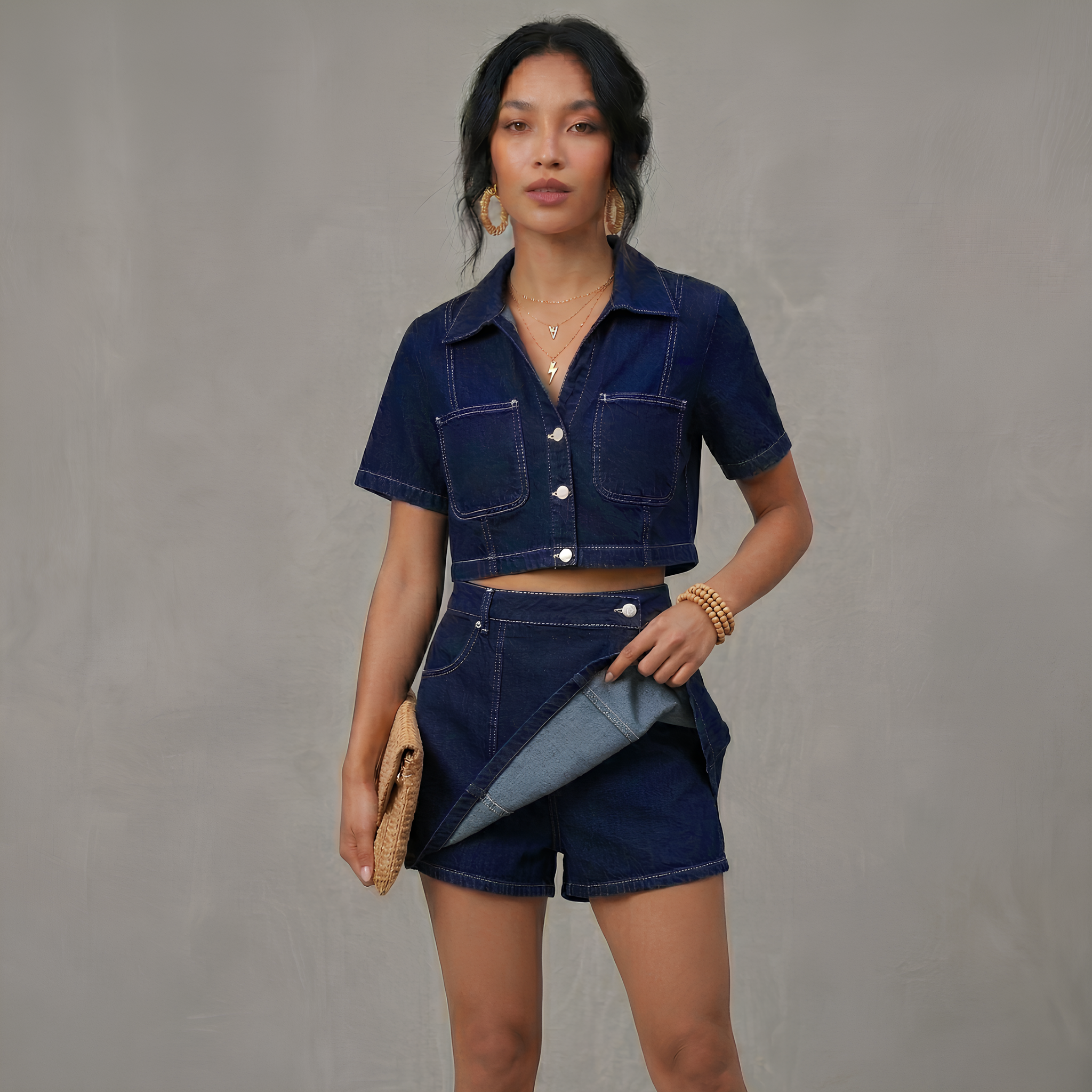Woman wearing a denim outfit against a gray background