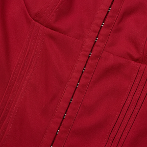 Close-up of a red fabric with stitching details