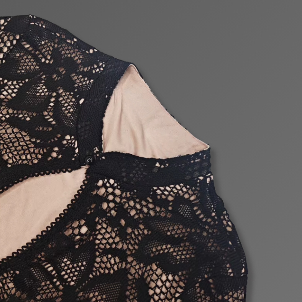 Navy blue lace garment on a gray background
