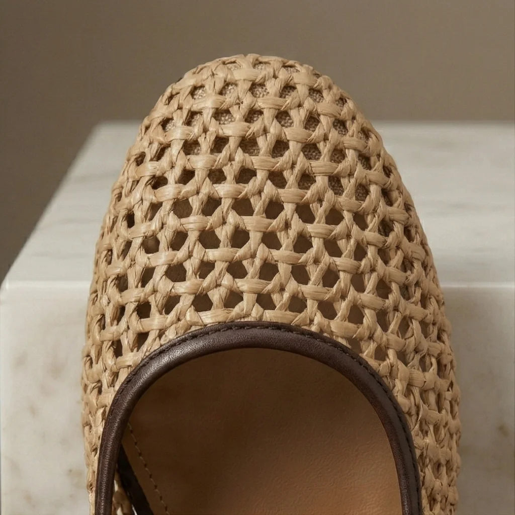 Close-up of a woven sandal on a marble surface