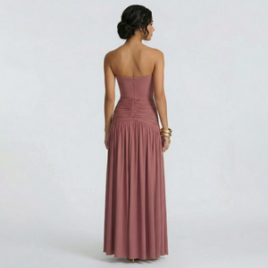 Woman wearing a strapless pink gown on a white background