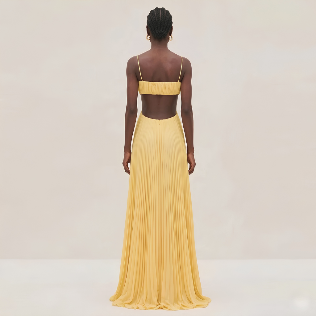 Woman wearing a yellow evening gown with a plain background