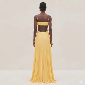 Woman wearing a yellow evening gown with a plain background