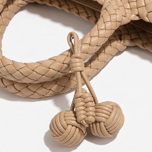 Beige braided leather lanyard with decorative knots on a white background