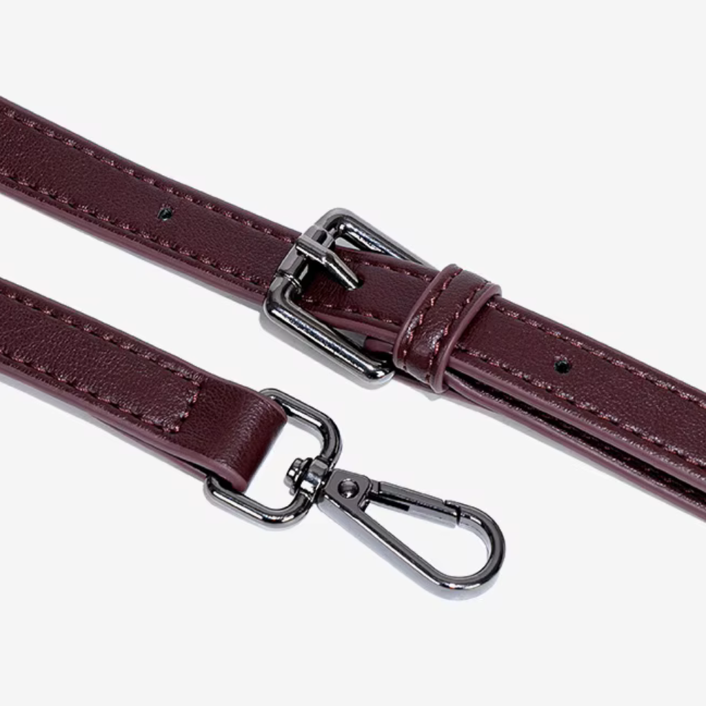 Two burgundy leather straps with silver metal clasps on a white background