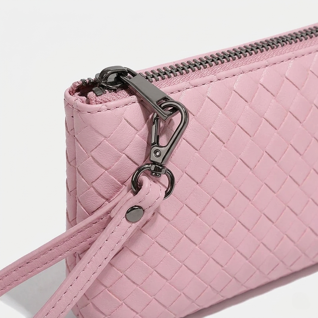Pink woven handbag with a zipper on a white background