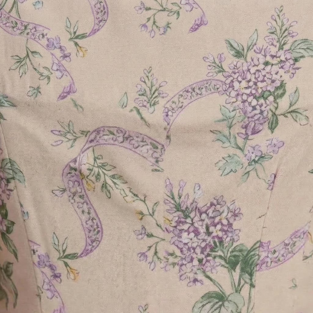 Floral pattern with purple flowers and green leaves on a beige background