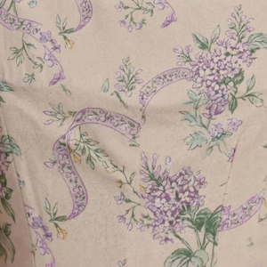 Floral pattern with purple flowers and green leaves on a beige background