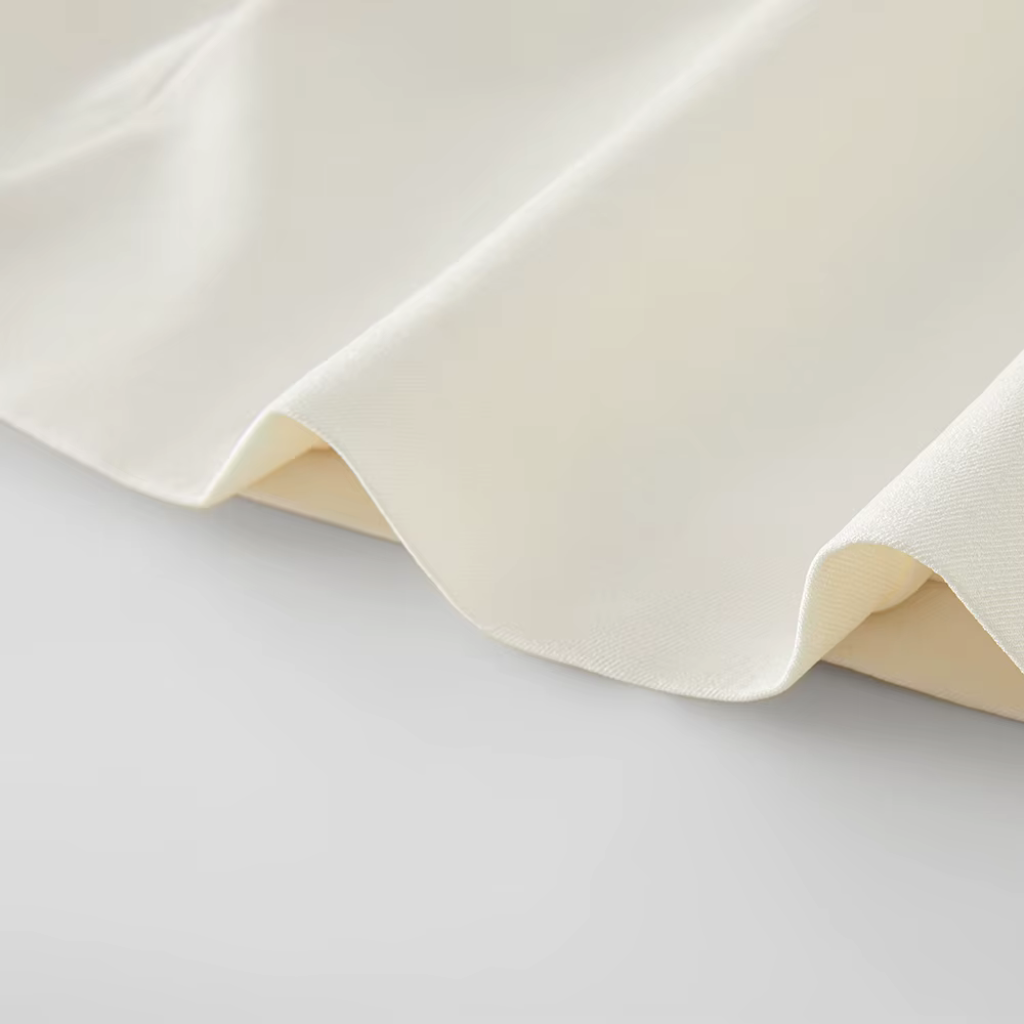 Close-up of beige fabric on a light gray background