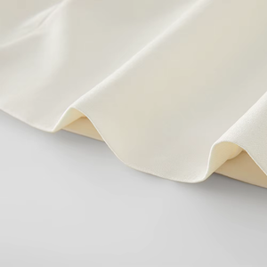 Close-up of beige fabric on a light gray background