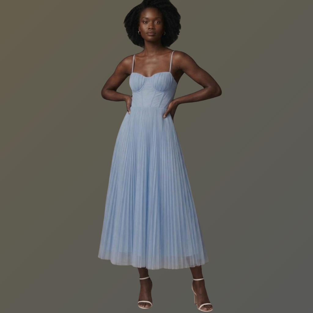 Woman wearing a light blue pleated dress on a dark background