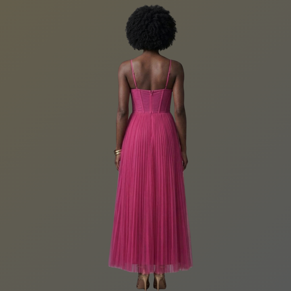 Woman wearing a pink dress with a plain background