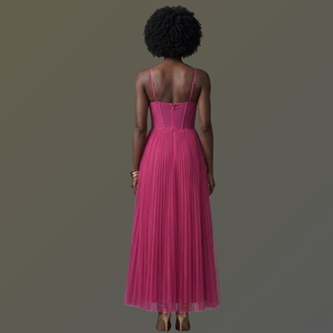 Woman wearing a pink dress with a plain background