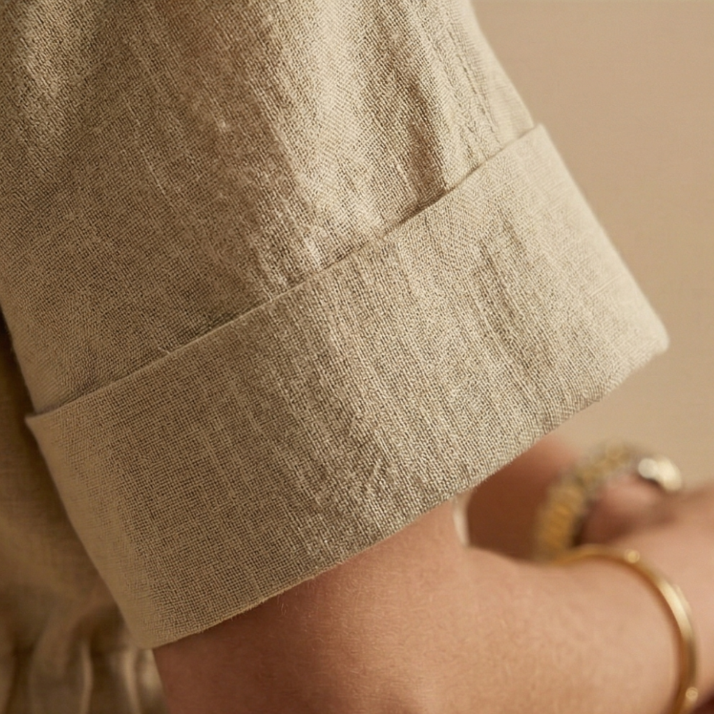 Close-up of a person wearing beige shorts with a blurred background