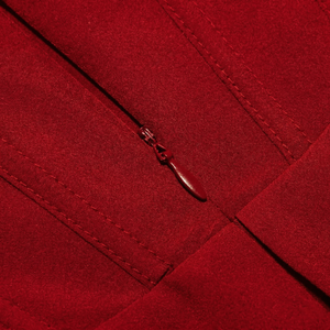 Close-up of a red zipper on a red fabric background