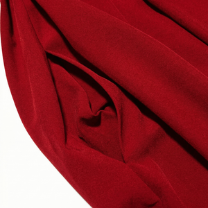 Close-up of red fabric with folds on a white background